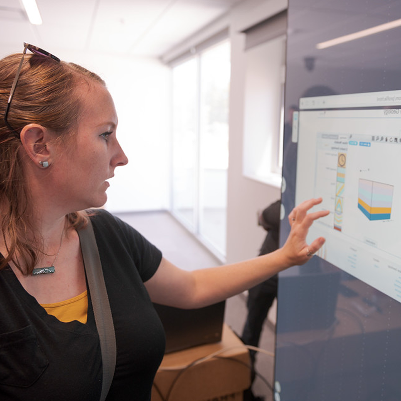 Dr. Tawny Tibbits, assistant professor, works with an interactive display during a training demonstration in the Math Science Center of Innovative Learning on May 26, 2022. The multi-user display can be used in a variety of ways for math and science faculty and students. (Photo by Daniel Binkard/Chadron State College)